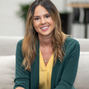 Smiling woman sitting on a sofa.